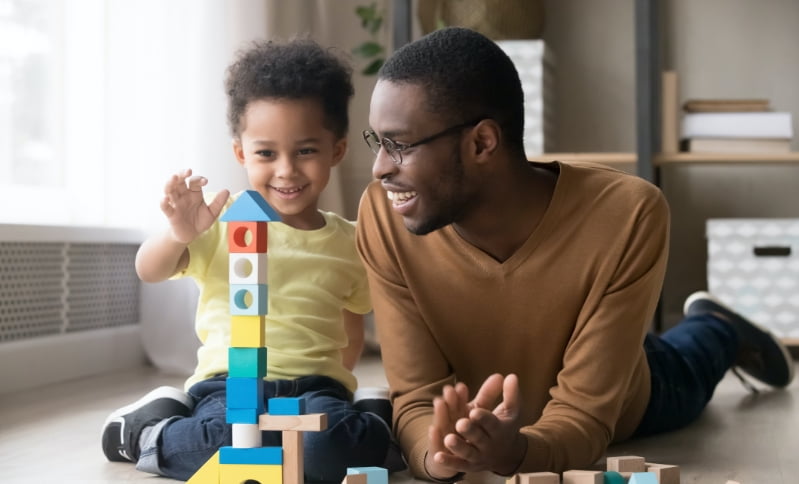 Man and child playing with blocks